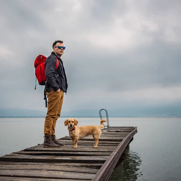 Man Standing Wooden Dock Stormy Weather His Dog Wearing Red — Stock Photo, Image