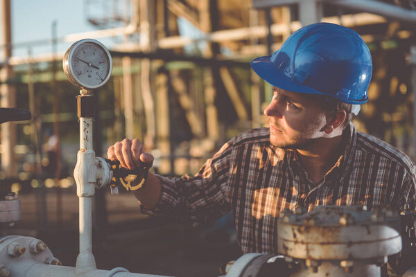 Man checking manometer in natural gas factory
