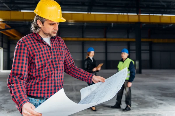 Construction Worker Safety Helmet Reading Blueprints — Stock Photo, Image