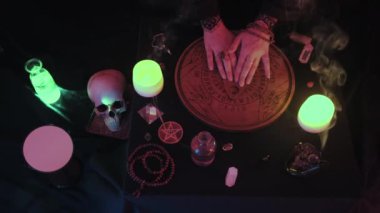 Medium top view of witchy hands spelling on WitchCraft Ouija Board Spirit Game