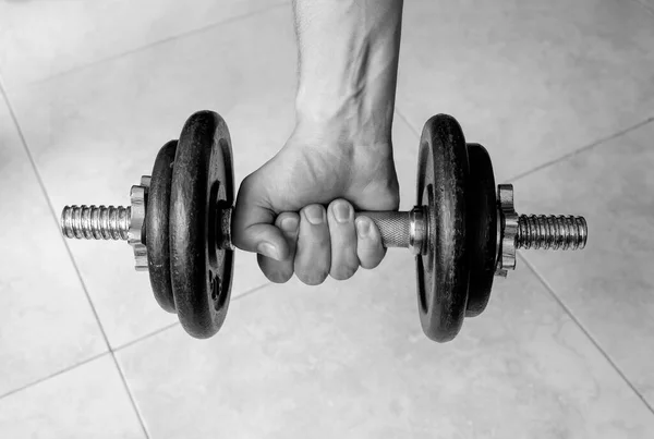 Erkek eli, eski bir demir dambılı sıkıyor. Spor, spor, sağlıklı yaşam, spor ve spor için ideal..