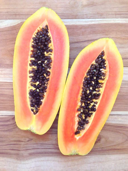 Slices of sweet papaya on wooden background — Stock Photo, Image