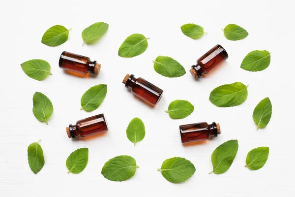 Mint  Essential Oil in a Glass Bottle with leaves. — Stock Photo, Image