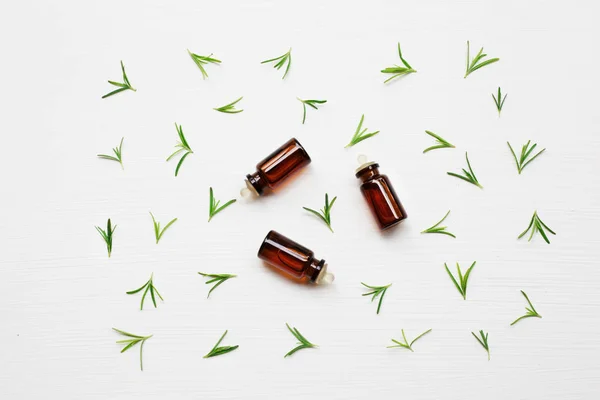 Rosemary essential oil with fresh leaves. — Stock Photo, Image