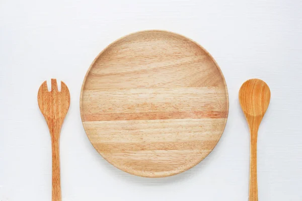 Wooden plat  with spoon and fork. — Stock Photo, Image