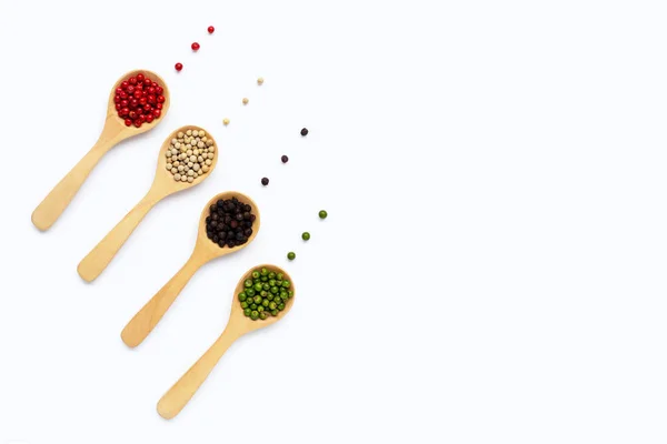 Green, red white and black peppercorns with wooden spoon on whit — Stock Photo, Image