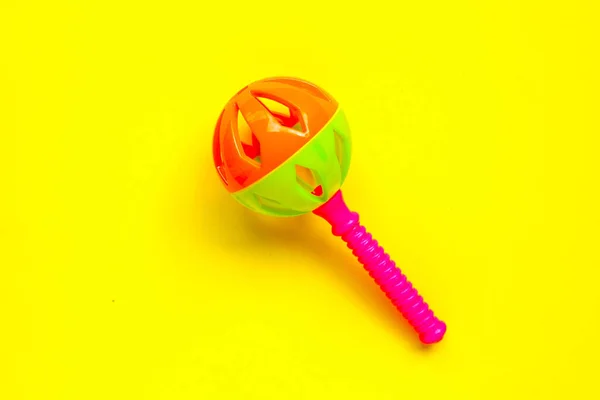 Colorful Baby Rattle Yellow Background — Stock Photo, Image