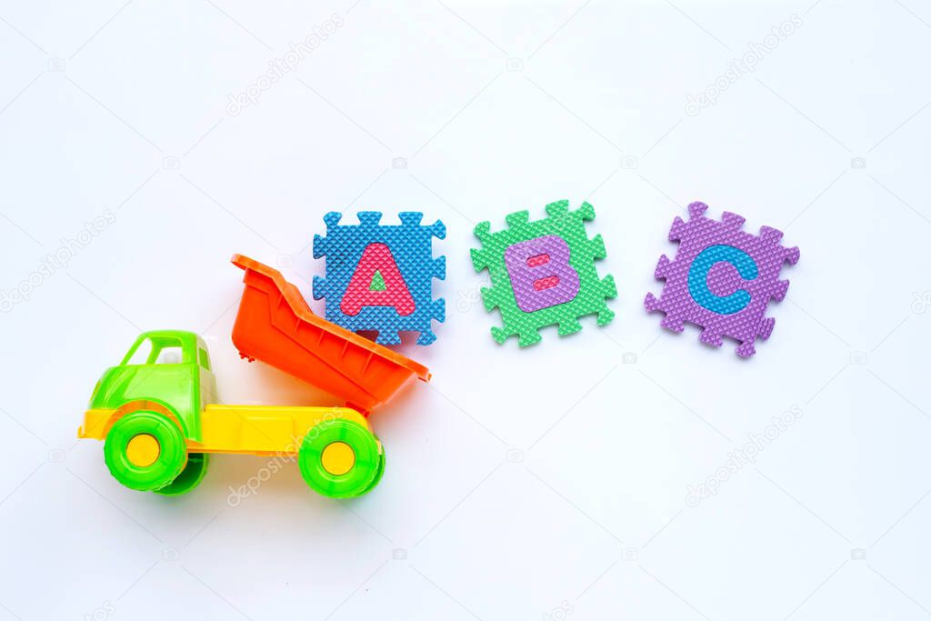 Colorful Kids toys with english alphabet puzzle on white background. Education concept, Copy space