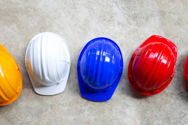 Construction helmets on concrete background. Top view