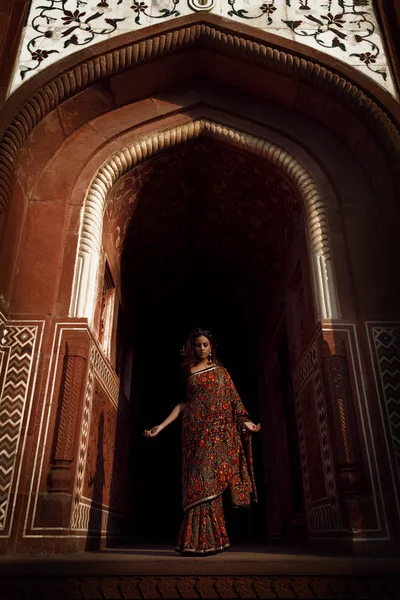 beautiful indian woman in sari in agra at taj mahal