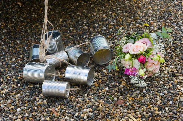 Tin cans and bridal bouquet — Stock Photo, Image