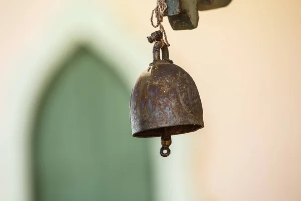 Old bell at the gate as a backdrop.