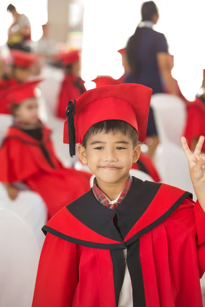 Asian boy Red graduation gown — Stock Photo, Image