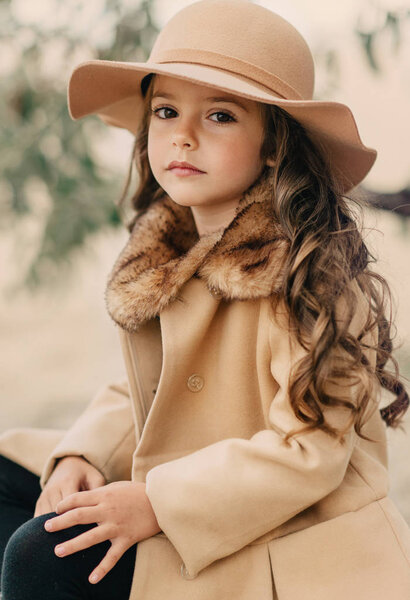 little girl in a hat with long hair