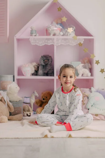 Ragazza in pigiama nella stanza dei bambini — Foto Stock