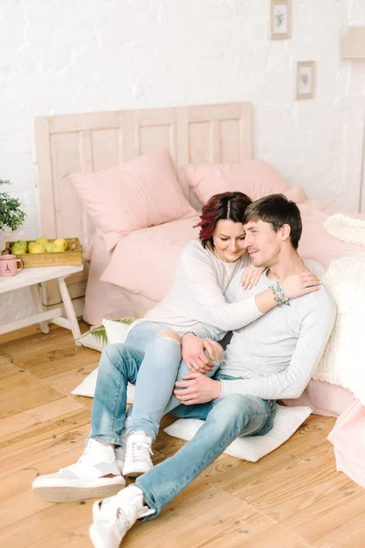 Couple in love sitting on the floor — Stock Photo, Image