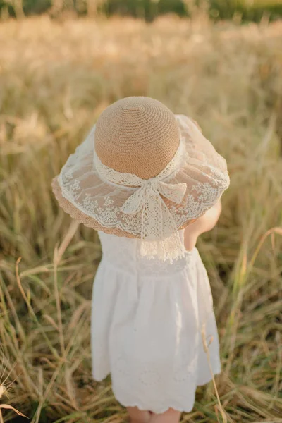 Meisje met hoed op het veld — Stockfoto