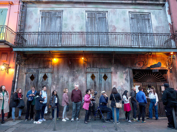 New Orleans, Louisiana, USA - 2020: People wait in line before a live performance by the Preservation Hall Jazz Band at the famous Preservation Hall, located in the French Quarter.
