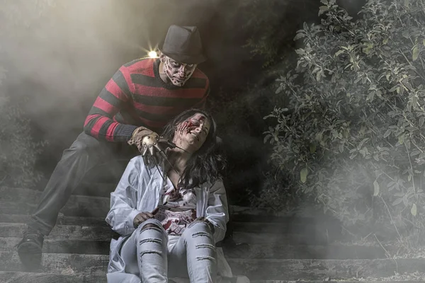 Un serial killer con un guanto nella nebbia con una ragazza — Foto Stock