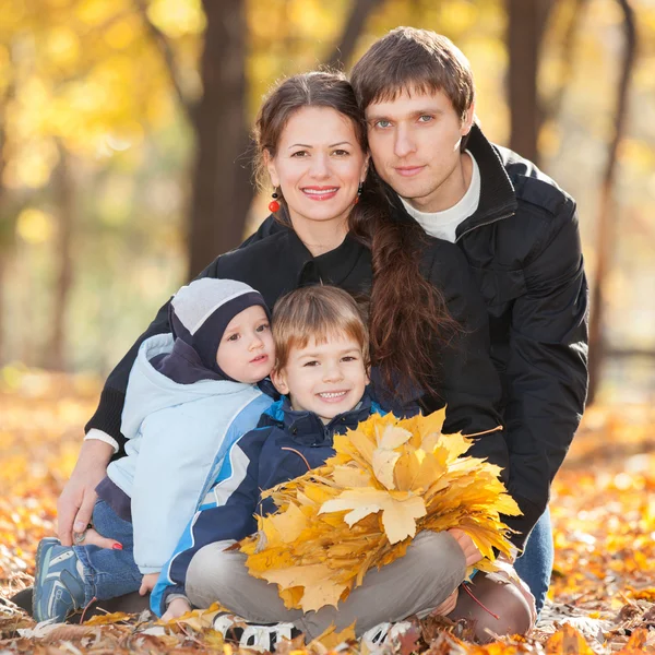 Happy family in the autumn park — Stock Photo, Image