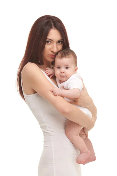 Portrait of mother and her young daughter in white. Happy family concept. Mother holding sweet baby isolated on white background — Stock Photo, Image