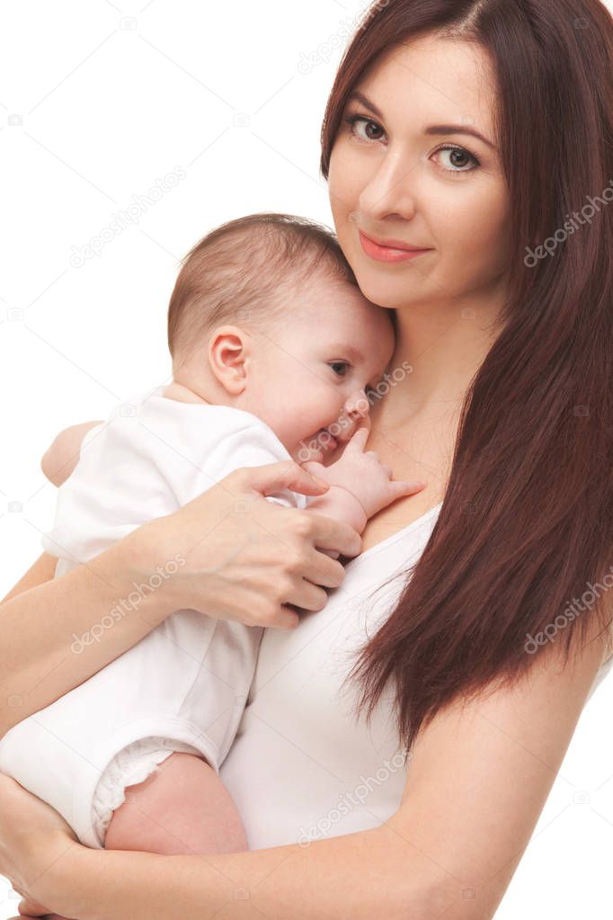 Portrait of mother and her little child in white. Happy family concept. Mother holding cute baby isolated on white background. . Motherhood and children concept. Close up