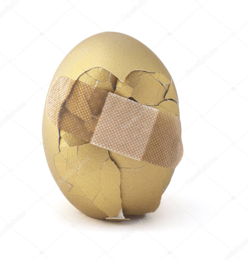 Cracked gold egg. Financial investment risk.