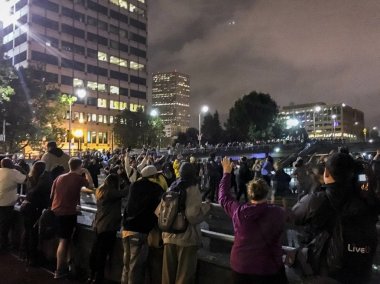 A diverse group of protesters blocking off a freeway onramp during a demonstration clipart