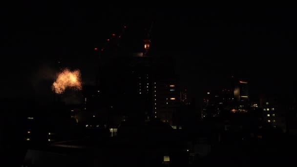 Fireworks near the building at the urban city in Tokyo at summer night — Stock Video