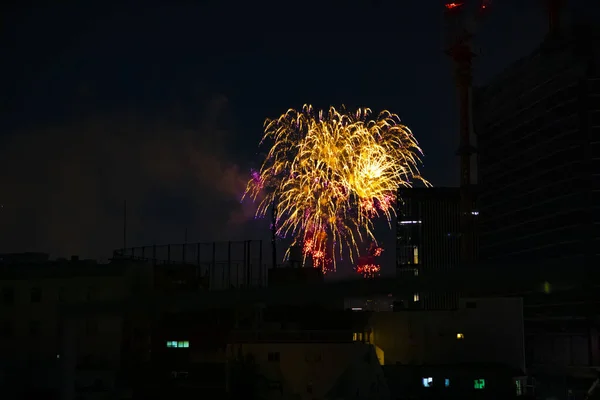 Fireworks near the building at the urban city in Tokyo at summer night