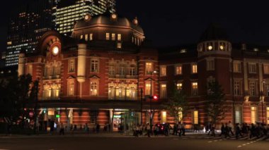 Tokyo 'daki iş kasabasında yürüyen insanların olduğu bir gece manzarası.