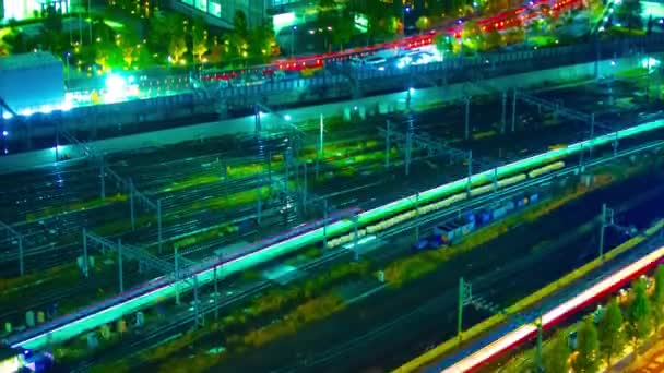 Een avond timelapse van spoorweg in Shinagawa Tokio hoge hoek lange schot tilt — Stockvideo