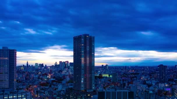 A dusk timelapse of cityscape in Tokyo high angle wide shot panning — Stock Video
