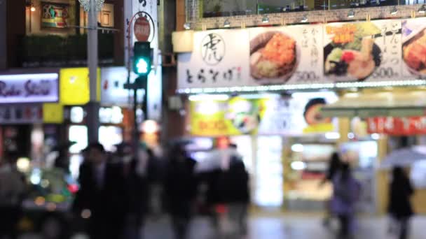 Caminhando pessoas no cruzamento em Shinjuku Tóquio dia chuvoso à noite — Vídeo de Stock