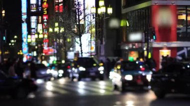 Walking people at the crossing in Shinjuku Tokyo rainy day at night
