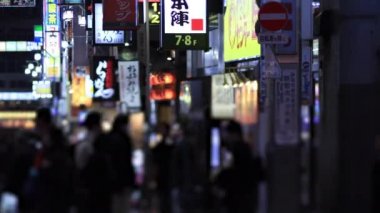 Walking people at the crossing in Shinjuku Tokyo rainy day at night