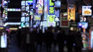 Walking people at the crossing in Shinjuku Tokyo rainy day at night