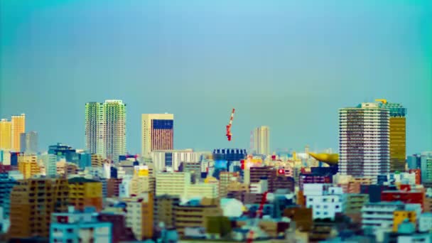 A timelapse of moving cranes at top of the building in Tokyo tiltshift tilting — 비디오