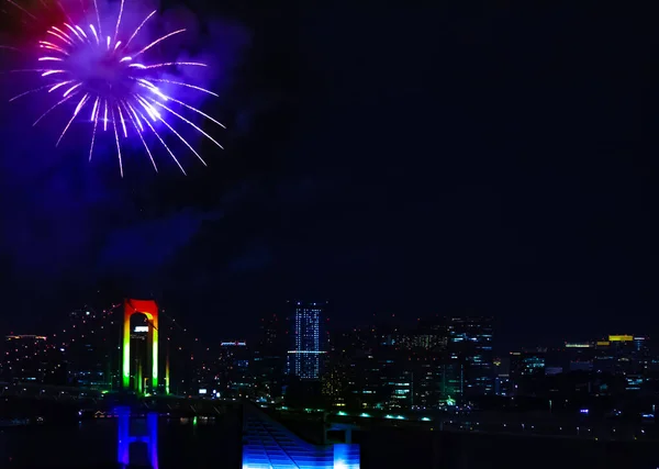 Un feu d'artifice nocturne près du pont Rainbow dans la ville urbaine de Tokyo — Photo