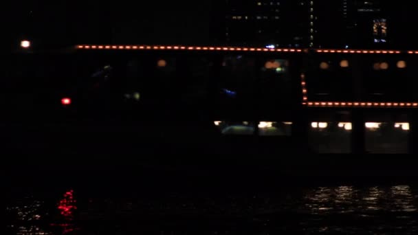 Moving neon boat nat the bay area in the urban city in Tokyo at night long shot — Stock Video