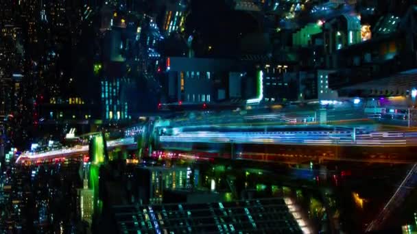 A night timelapse of the highway in Shibuya Tokyo high angle vertical shot panning — Stock Video