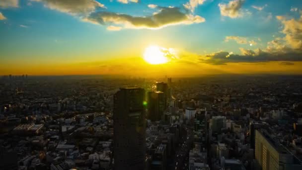 A sunset timelapse of panoramic urban cityscape in Tokyo high angle wide shot tilt — Stock Video