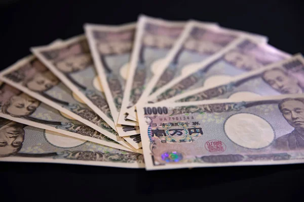日本货币100,000日圆的黑色背景特写 — 图库照片