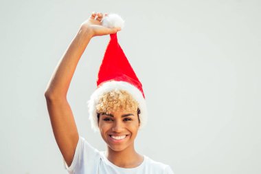 african american girl with snow-white smile and curly blonde hair wearing red hat , looking at camera in studio white background clipart