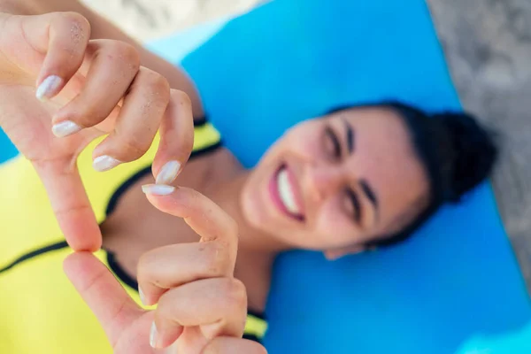 Mujer india joven practica asanas en estera yóguica azul en la playa de goa. ella vistiendo polainas amarillas con estilo y sujetador superior fitness — Foto de Stock