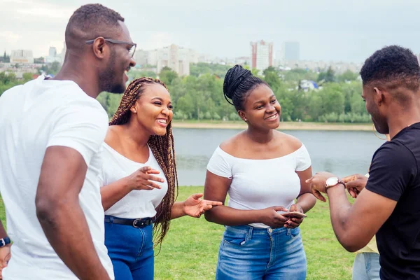 Friendship young millennial multi-ethnic afro braids dreadlocks friends talking spending weekend together autumn cloudy evening — Stock Photo, Image