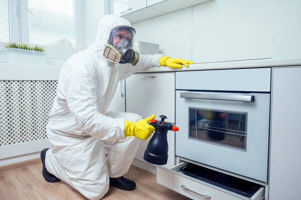nice Worker spraying pesticide on induction hob