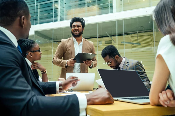 Well-dressed business indian men making a report to subordinate employees in a modern office — Stock Photo, Image