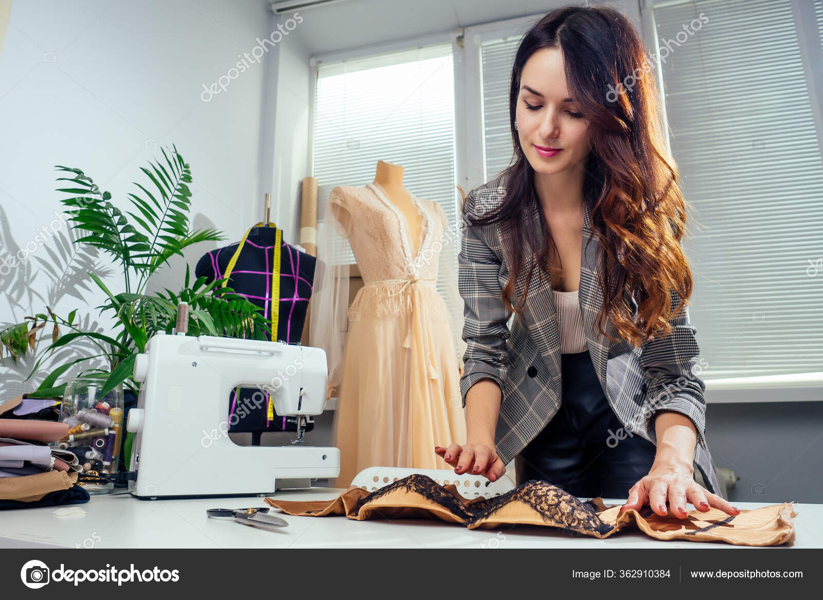 Caucasian tailor woman sewing lingerie in showroom ,she sewing