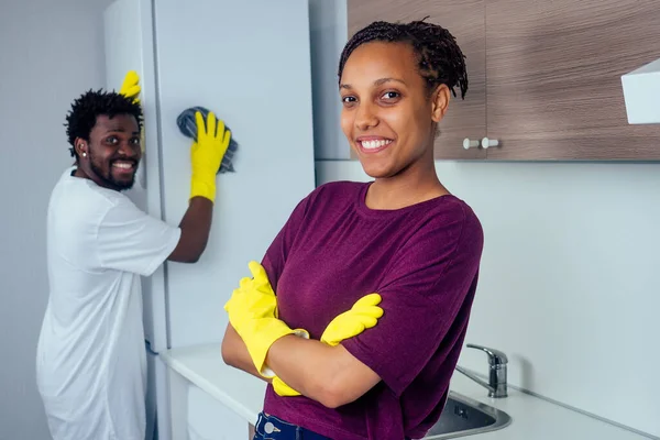 Man and woman cleaning the kitchen at home